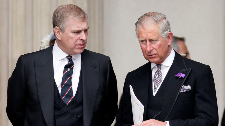 Prince Andrew and King Charles talking