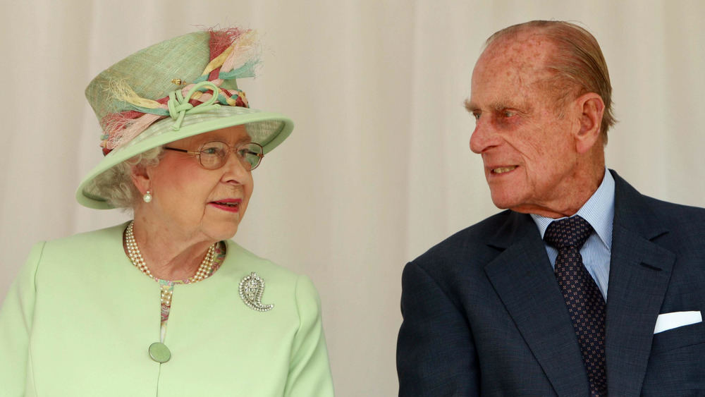 Queen Elizabeth chats with Prince Philip at a royal engagement