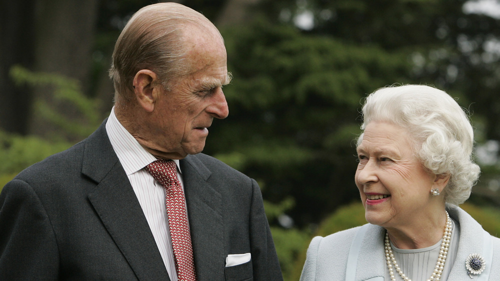 Prince Philip and Queen Elizabeth smiling at each other