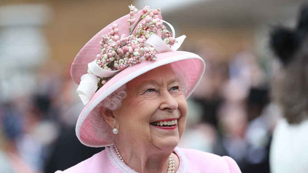 Queen Elizabeth pink hat smiling