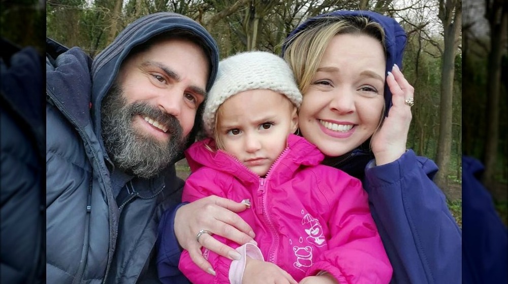 Jon, Lucy and Rachel are all smiles in rainy England