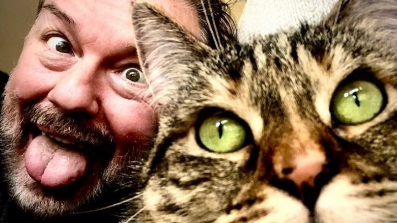 Ricky Gervais funny face with cat