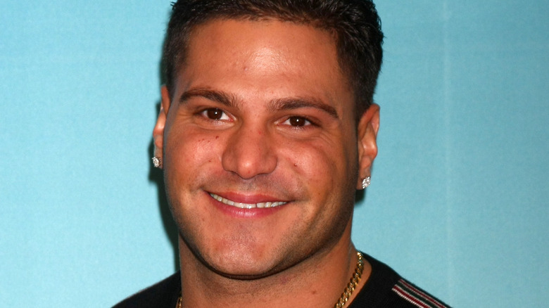 Ronnie Ortiz-Magro stands in front of turquoise background