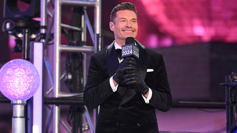 Ryan Seacrest holding a mic