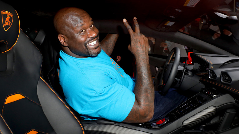 Shaquille O'Neal smiling in a car 