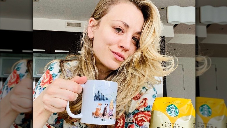 Kaley Cuoco smiling with a coffee mug