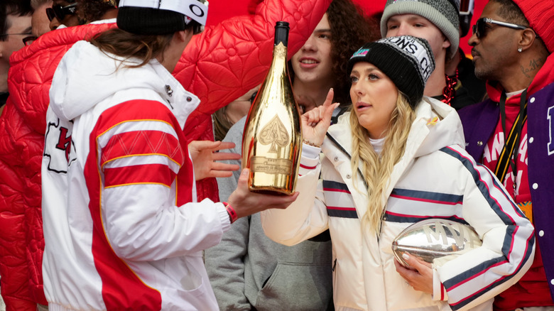 Brittany Mahomes gesturing about champagne