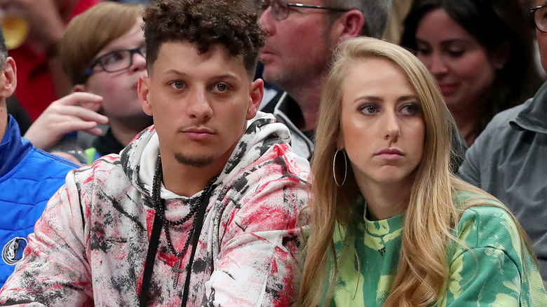 Brittany Mahomes sitting with Patrick Mahomes