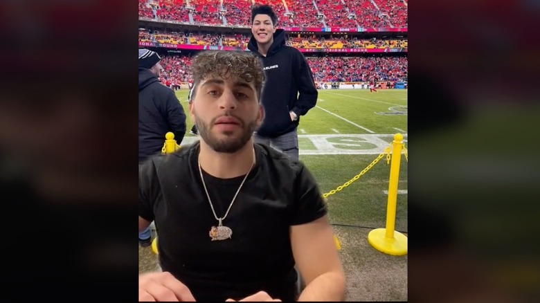 Sam Farha in front of picture of Jackson Mahomes