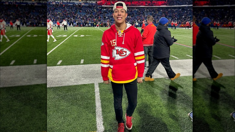 Jackson Mahomes stands on football field sidelines