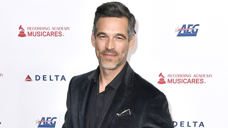 Eddie Cibrian smiling, wearing velvet jacket