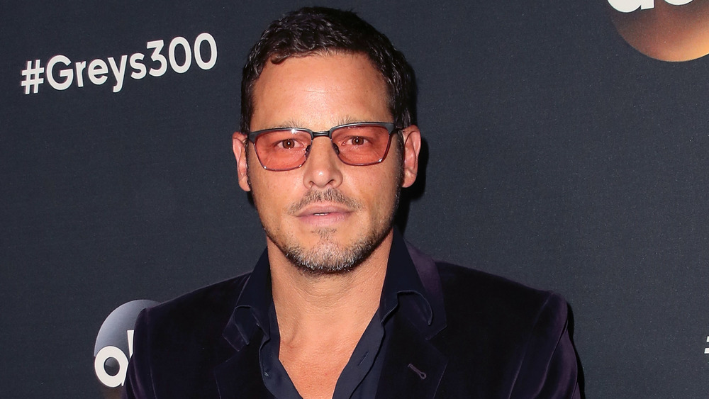 Justin Chambers wearing red-tinted glasses 