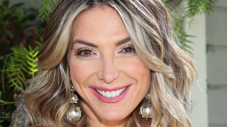 Debbie Matenopoulos smiling with trees