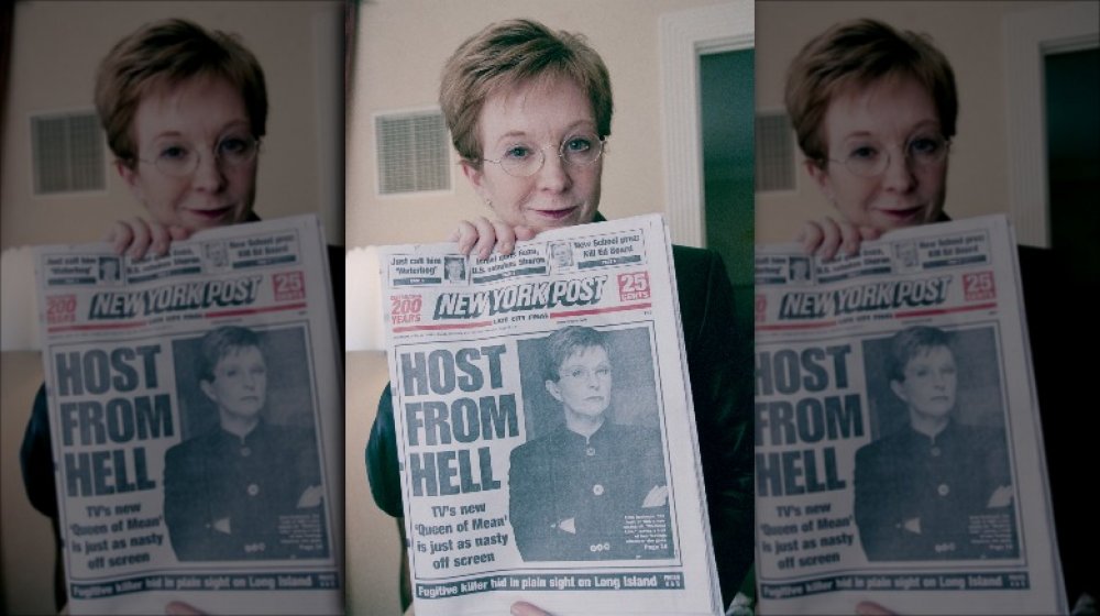 Television presenter Anne Robinson holding up a news paper