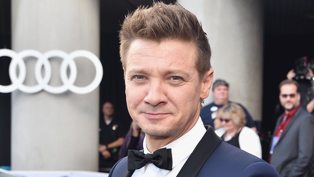 Jeremy Renner in a bow tie and navy suit