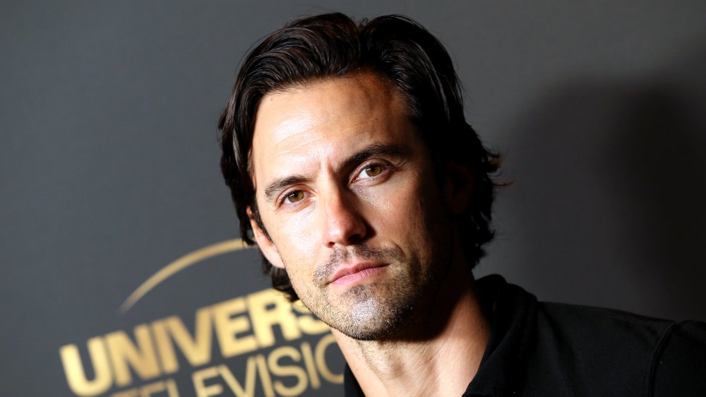 Milo Ventimiglia in front of a Universal wall on the red carpet