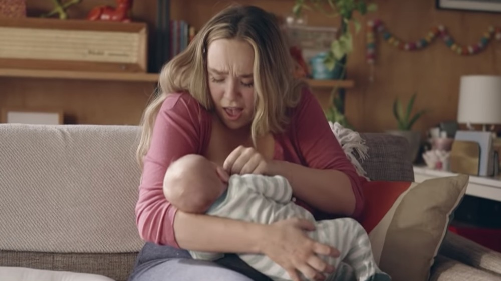 Mother breastfeeding baby in Frida Mom commercial