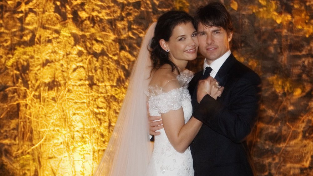 Katie Holmes and Tom Cruise embracing at their wedding