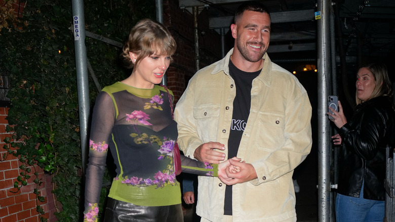 Taylor Swift and Travis Kelce holding hands