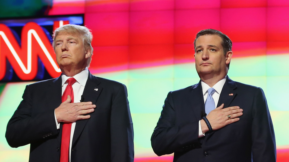 2016 Republican presidential candidates Donald Trump and Sen. Ted Cruz (R-TX), listen to the national anthem before the start of the CNN debate.