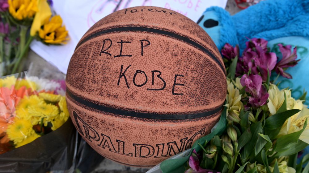 People mourn at a makeshift memorial at Mamba Sports Academy for former NBA great Kobe Bryant