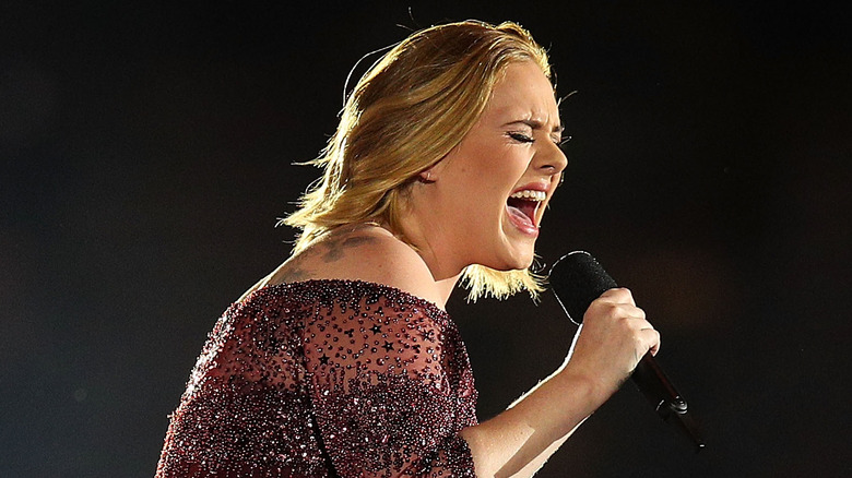 Adele singing into microphone