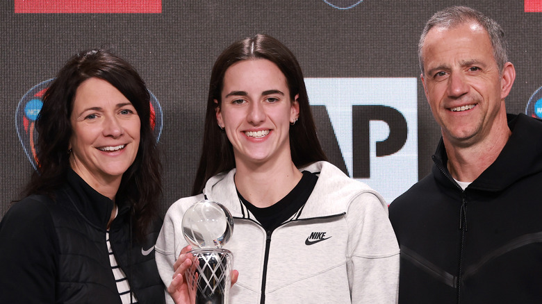 Caitlin Clark smiling with her parents, Anne and Brent