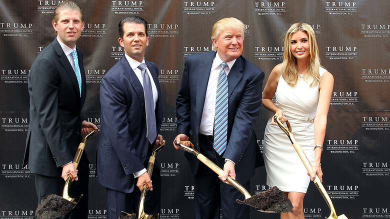 Ivanka Trump shovelling dirt with Donald Trump and her brothers