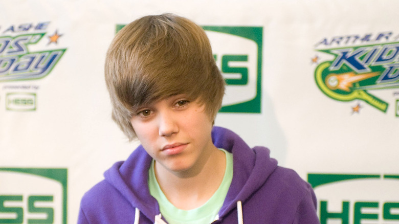 Justin Bieber wearing a purple hoodie 