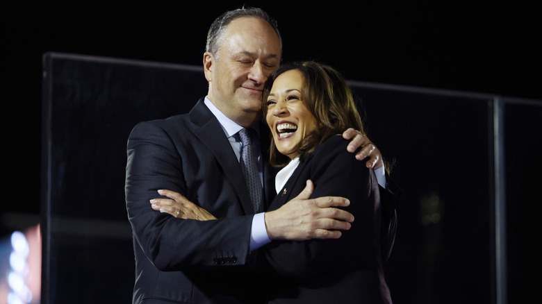 Doug Emhoff hugging Kamala Harris during a campaign event