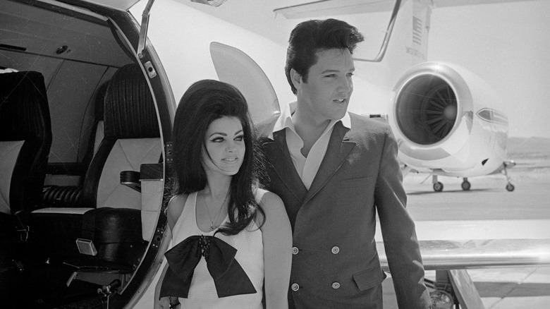 Priscilla Presley and Elvis Presley on airstrip