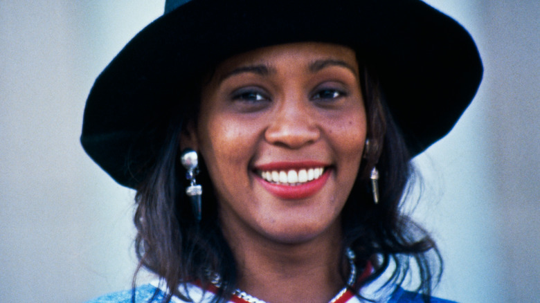 A young Whitney Houston smiles