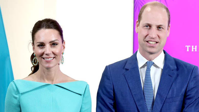 Kate middleton and prince william standing and smiling