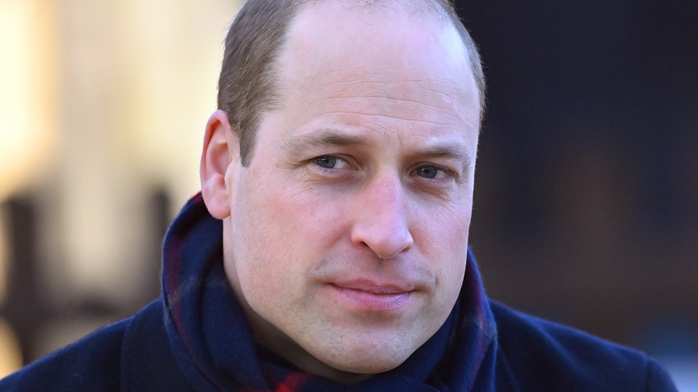 Prince William listening to someone speak at an event