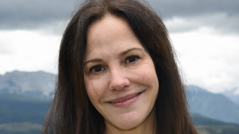 Mary-Louise Parker standing in front of mountains