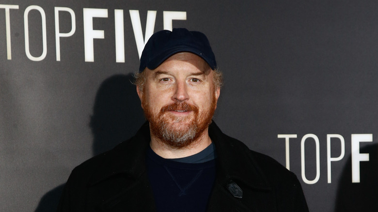 Louis C.K. in black baseball cap