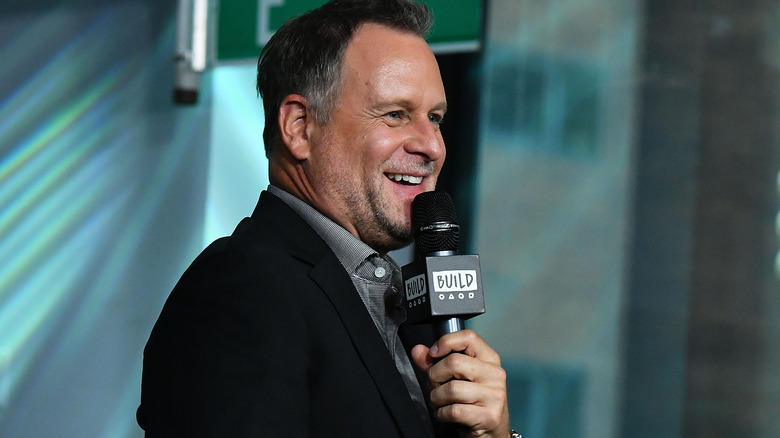 Dave Coulier smiling into mic