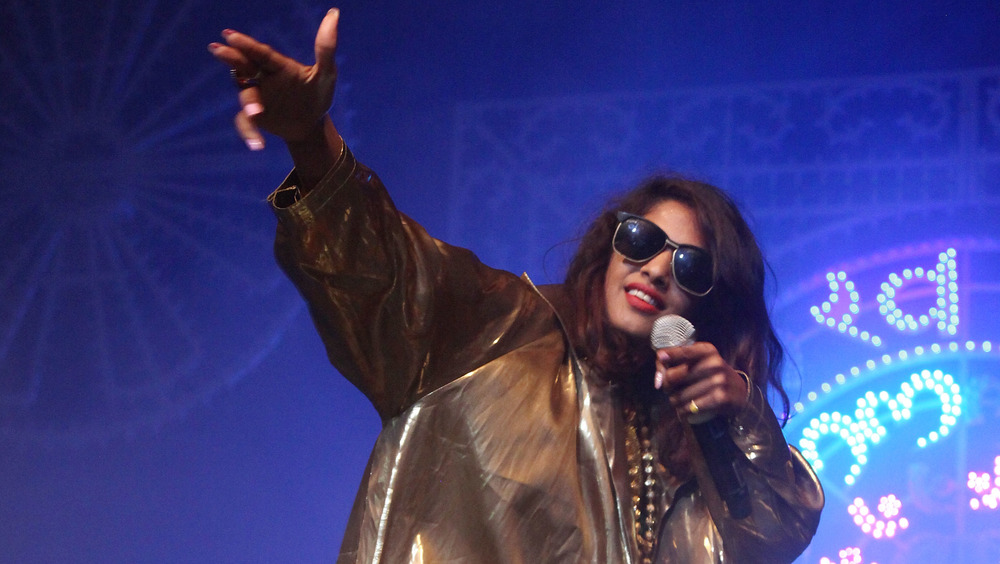 M.I.A. throwing up a gun sign with her fingers