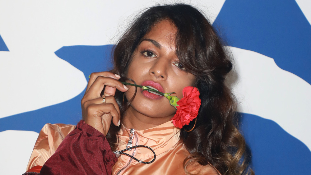 M.I.A. with rose stem in her mouth