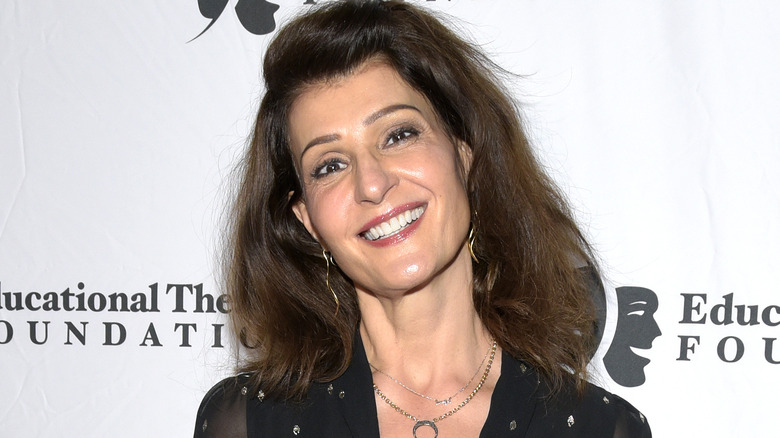 Nia Vardalos smiling and tilting head