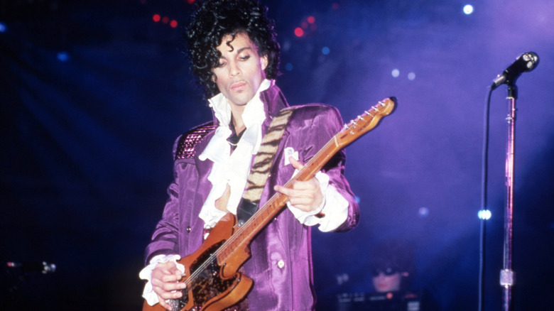 Prince plays guitar