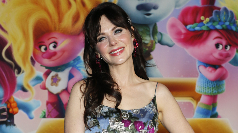 Zooey Deschanel smiling at the Trolls movie premiere