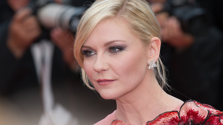 Kirsten Dunst facing left petal earrings