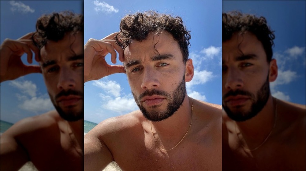 Brendan Morais posing for a selfie at the beach