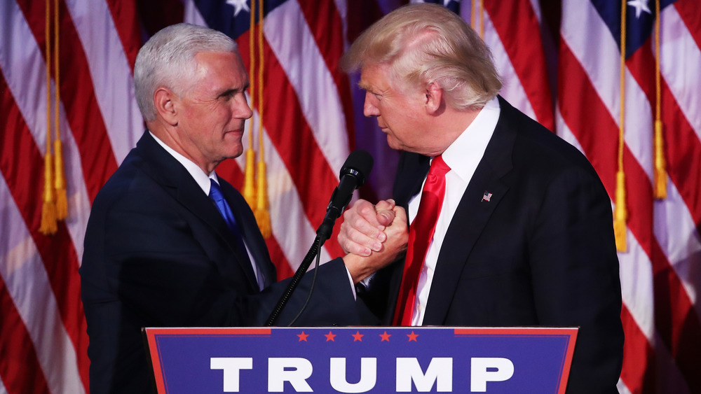 Mike Pence and Donald Trump holding hands