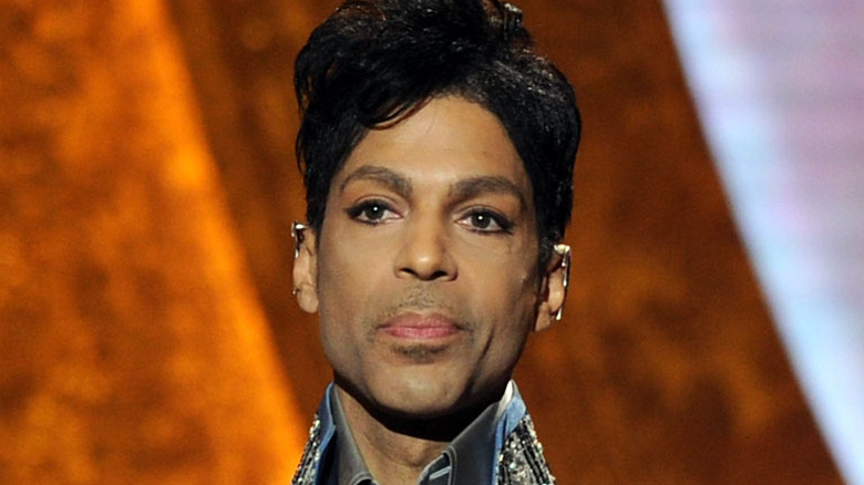 Prince presents an award on stage