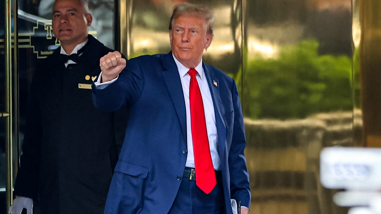 Donald Trump leaving raising fist while leaving Trump Tower