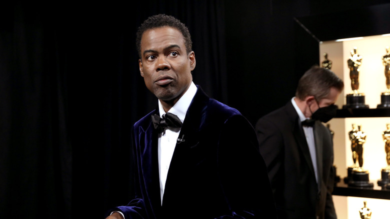 Chris Rock standing backstage during the 94th Annual Academy Awards