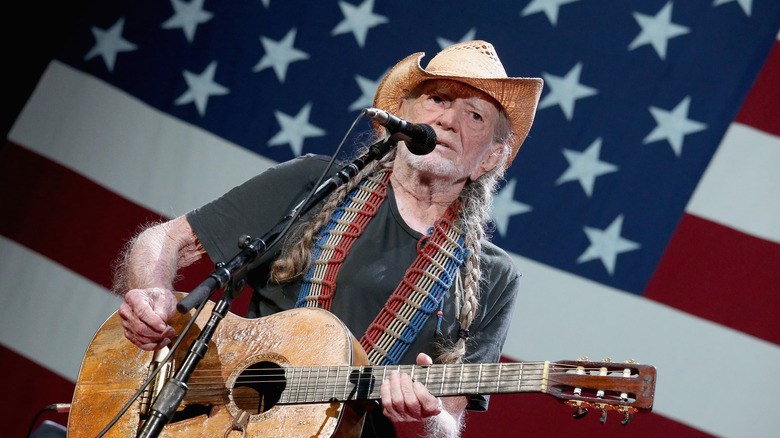 Willie Nelson playing guitar