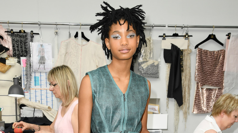 Willow Smith posing in seamstress workshop